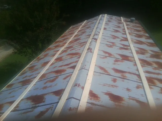 Rusted metal roof panels with new wood purlins before replacement — Storm Damage Roof Repair in Ringwood by Roofing Brothers